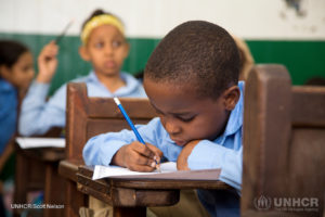 An African youngster studies hard during a children's education program at the St. Andrew's Refugee Services centre in Cairo in 2016